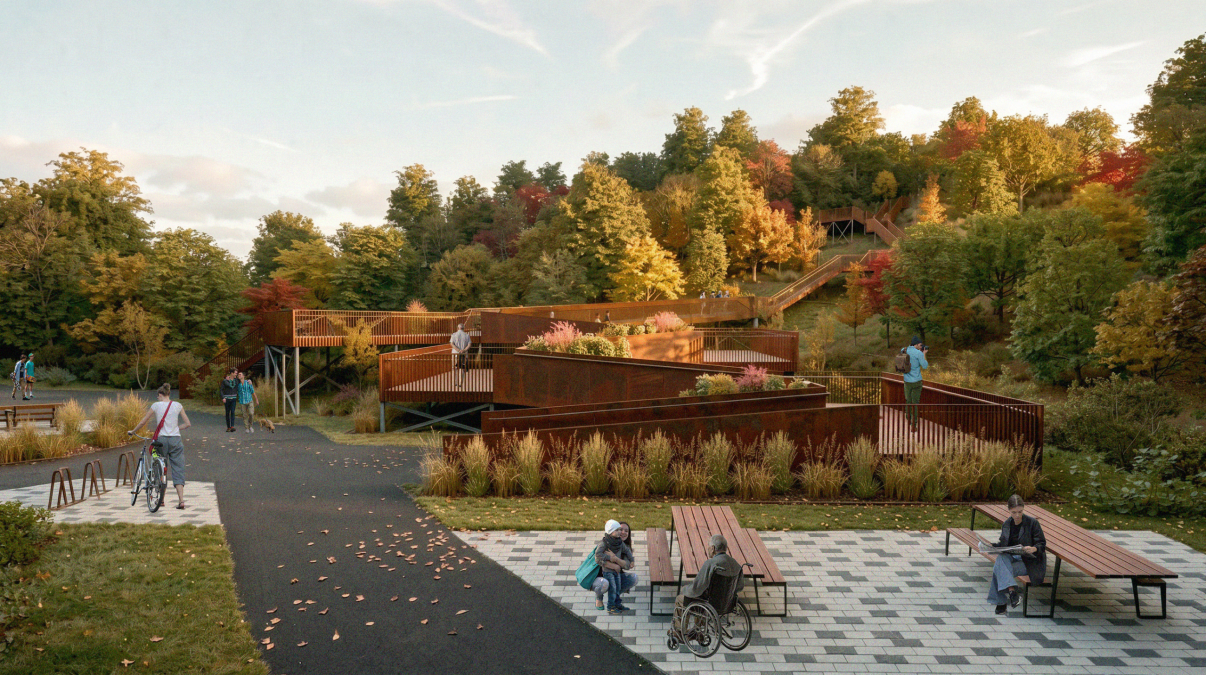 Aire de repos accessible avec bancs et tables de pique-nique, au pied des parois d'acier corten menant au sentier boisé de la passerelle